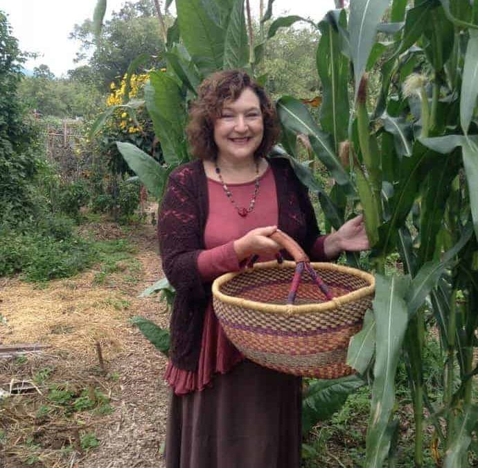 Denise picking corn in the community garden