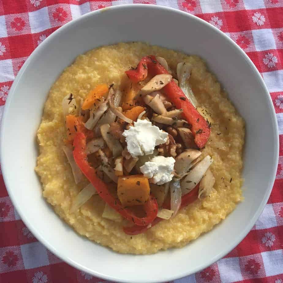 Local mushrooms roasted with other veggies over grits and topped with goat cheese