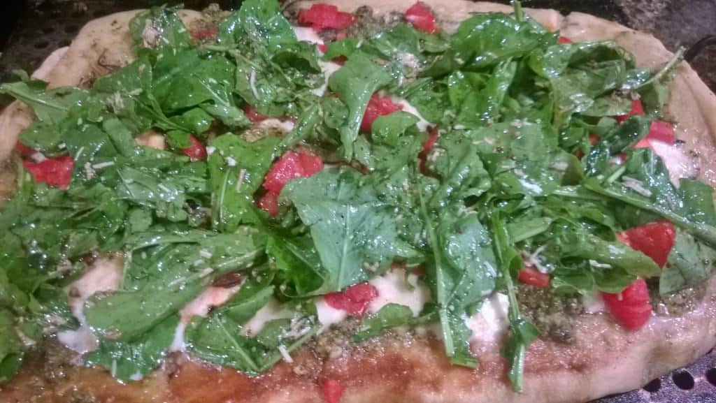 A great topping for the grilled pizza is a fresh arugula salad